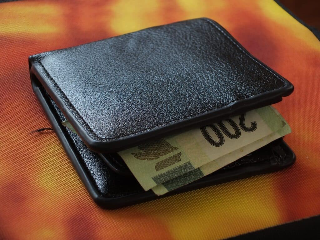 A picture of a wallet with cash inside.