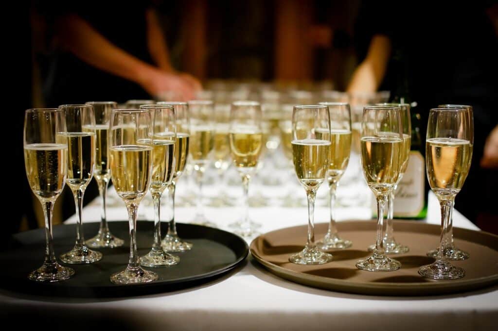 Many glasses of champagne within champagne glasses.