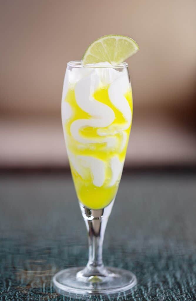 A limoncello glass with lime on top.