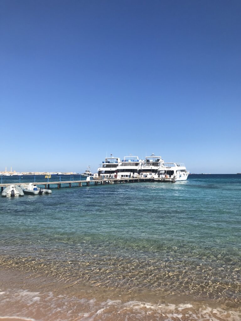 Some yachts docked near a beach