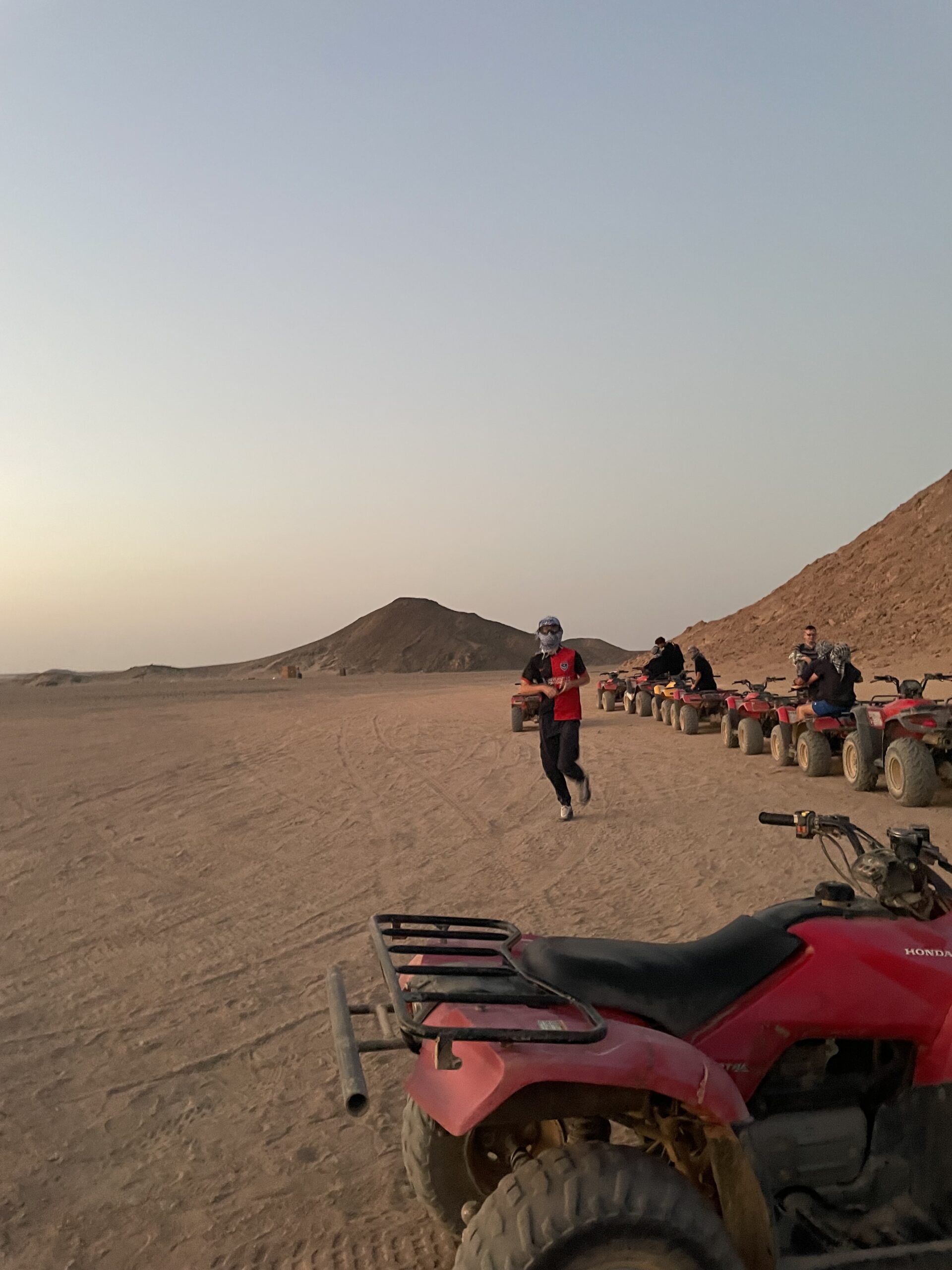 The Author's brother running near some quad bikes.