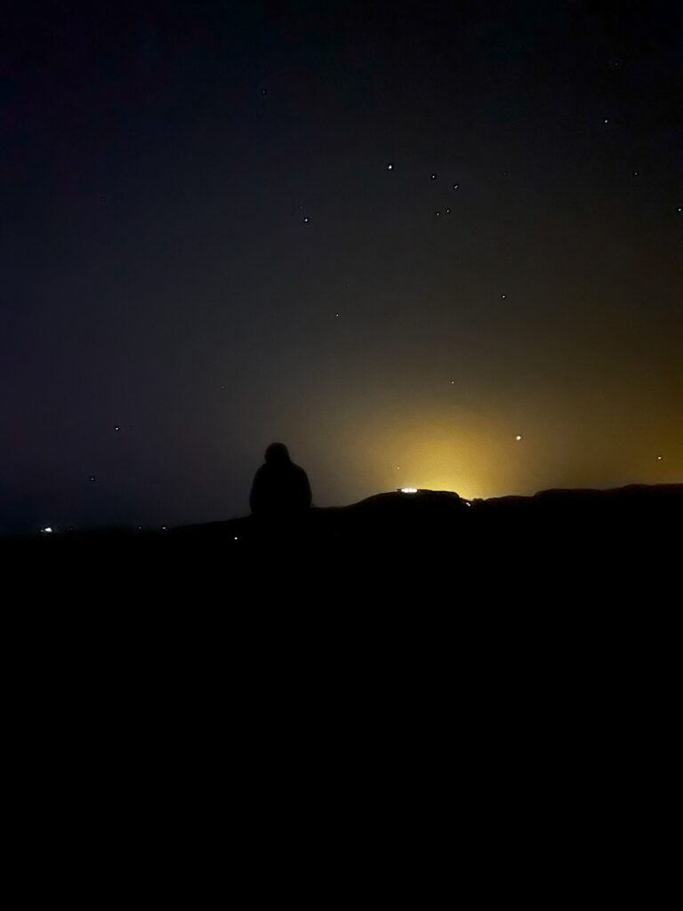 The authors brother can be seen with the stars of the night sky in the background.