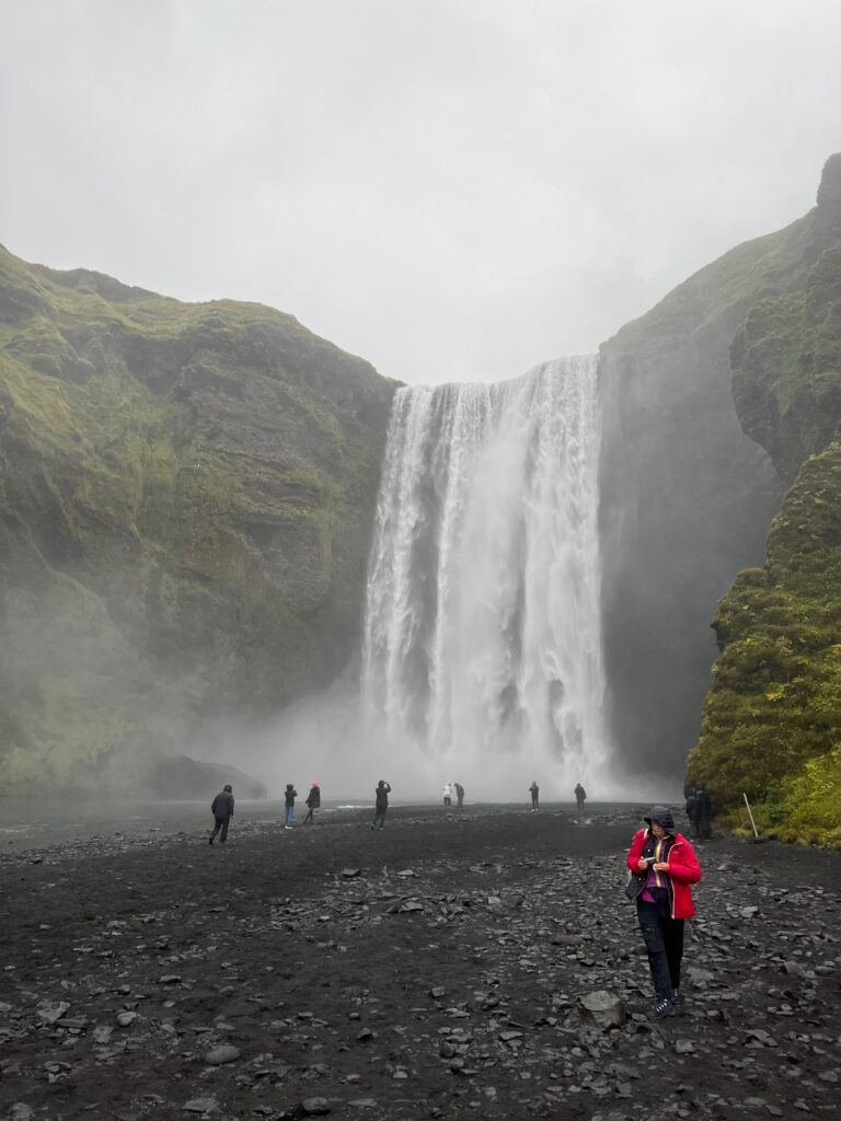 Skógafoss waterfall as seen on a cloudy day from the near the bottom of the waterfall.