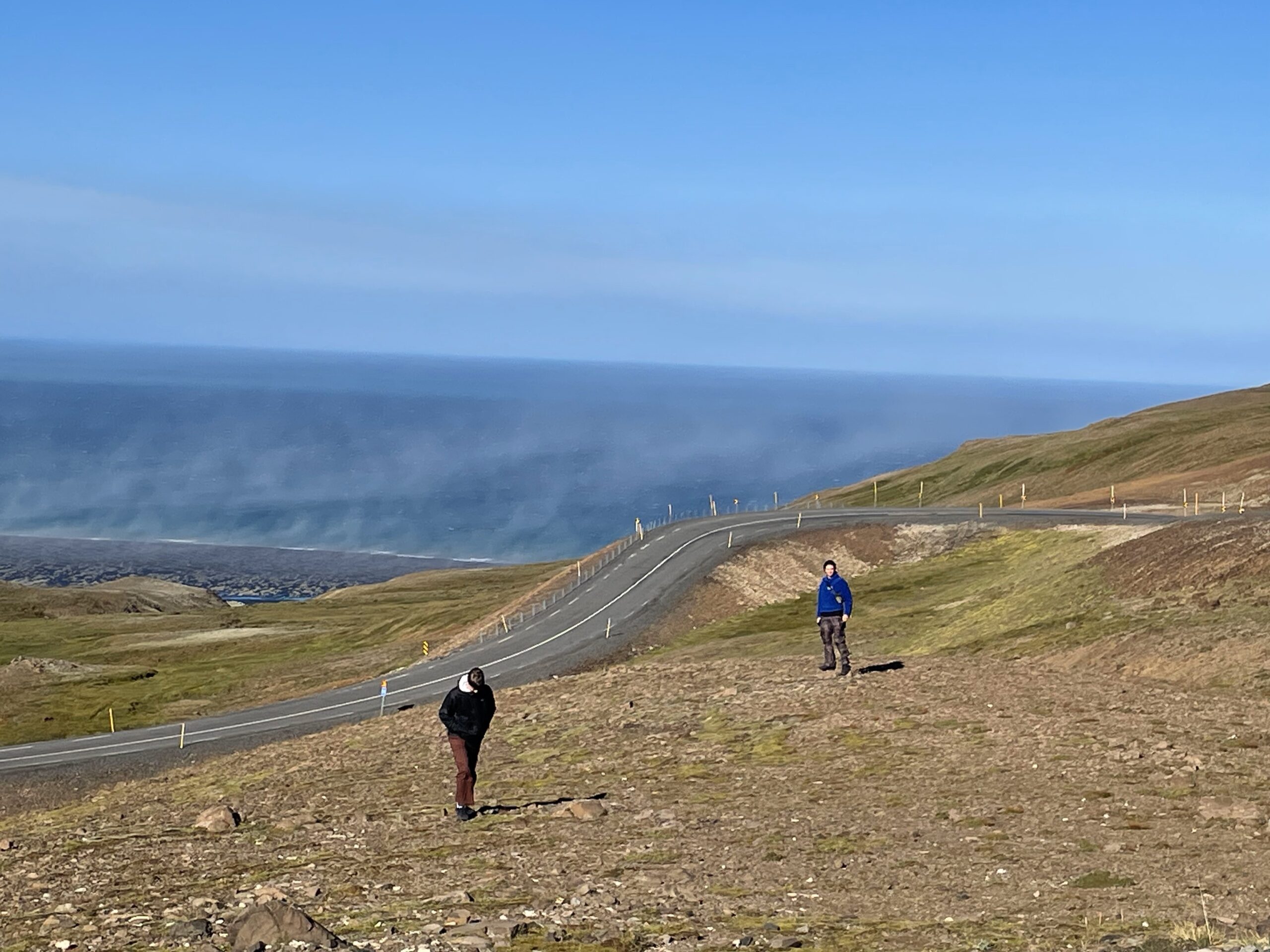 The author and his brother stood on a mountain edge in front of the Arctic Sea.