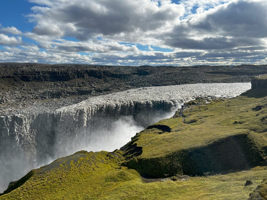 The mighty Dettifoss waterfall from a high perspective. The force of the water can be seen in its weird shape.