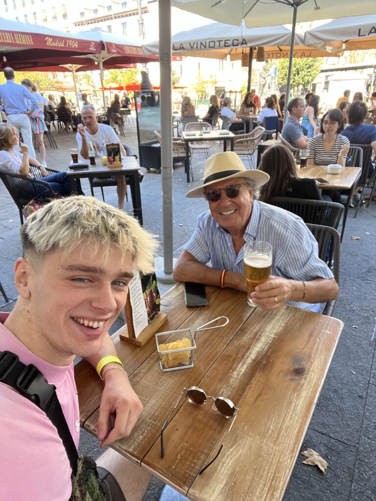 The author Tom sat having a drink with an old man called Toni that he met in Madrid.