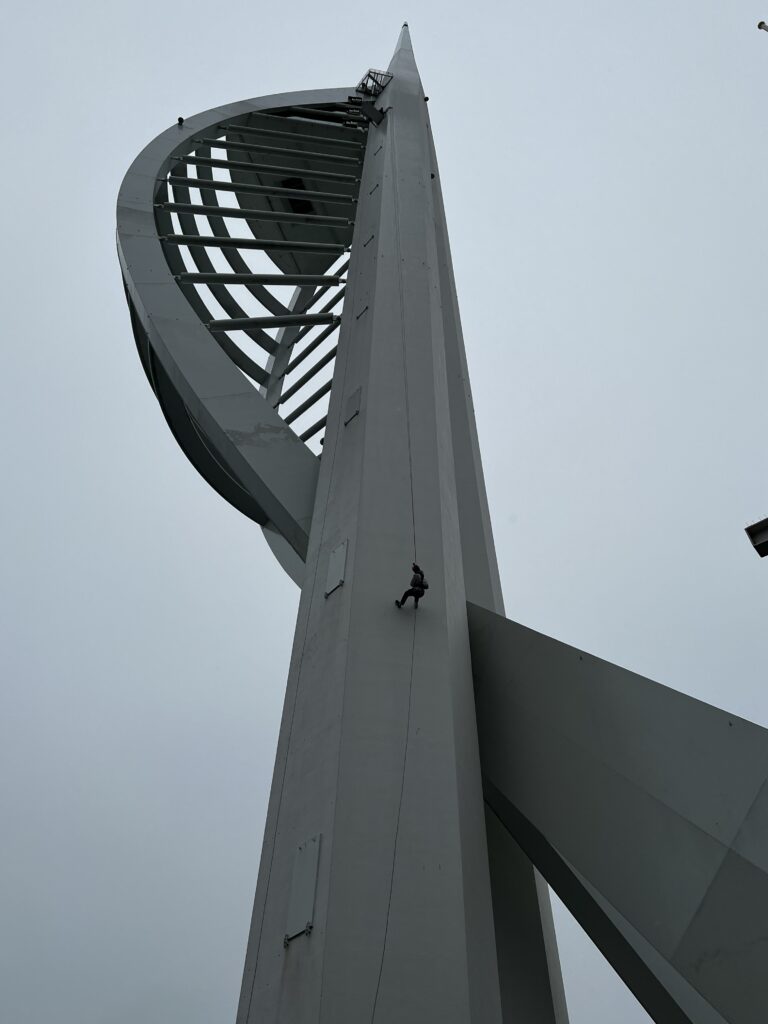 The author abseiling down the Spinnaker Tower, Portsmouth, on a cloudy day.