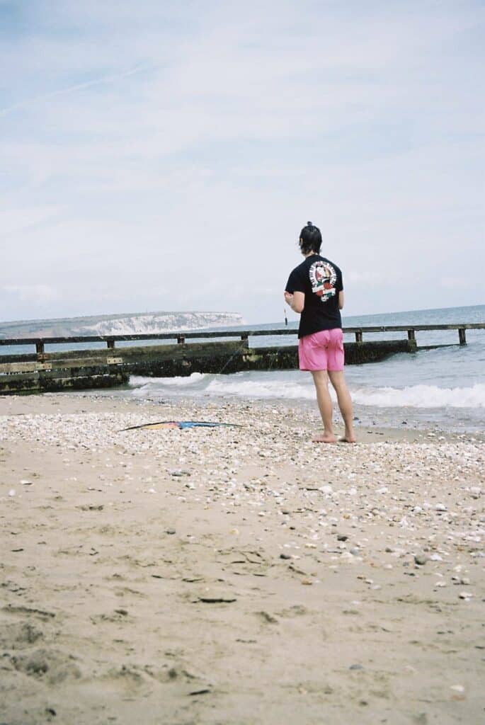 The author, Tom, holding a kite that won't get off the floor on the Isle of Wight