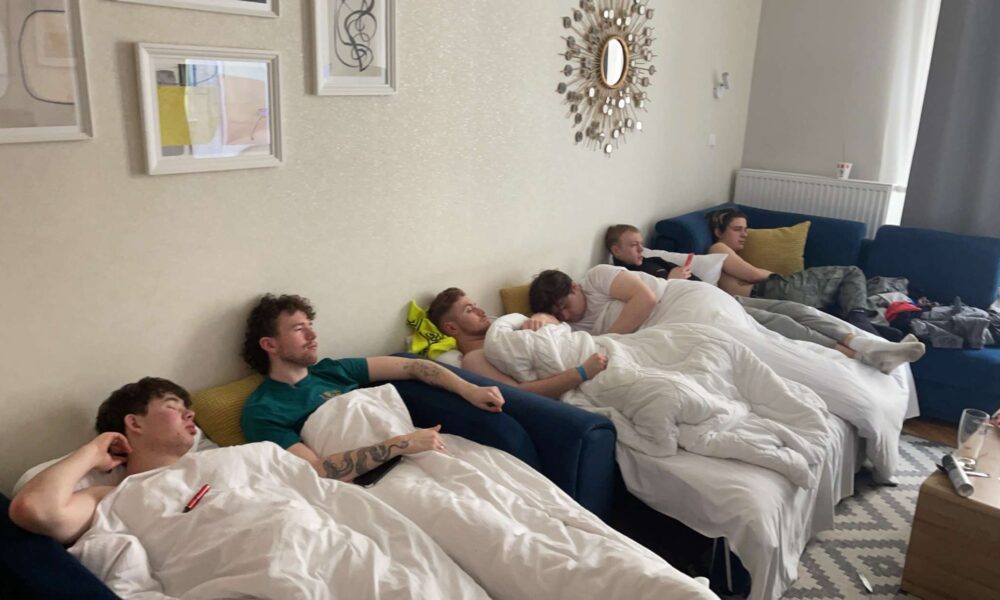 The author and 5 friends hungover in an apartment in Poland