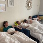 The author and 5 friends hungover in an apartment in Poland