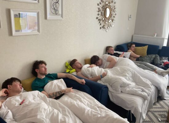 The author and 5 friends hungover in an apartment in Poland