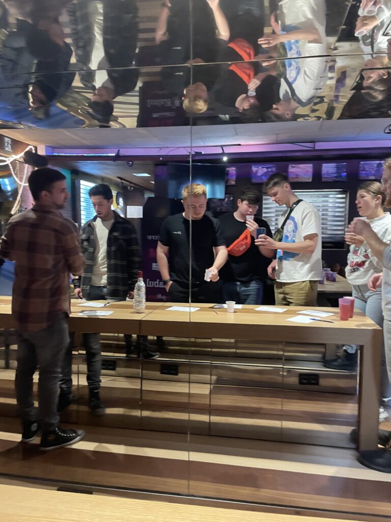 The auhtor and his friends taking a mirror selfie during a wine tasting session in a Barcelona hostel.