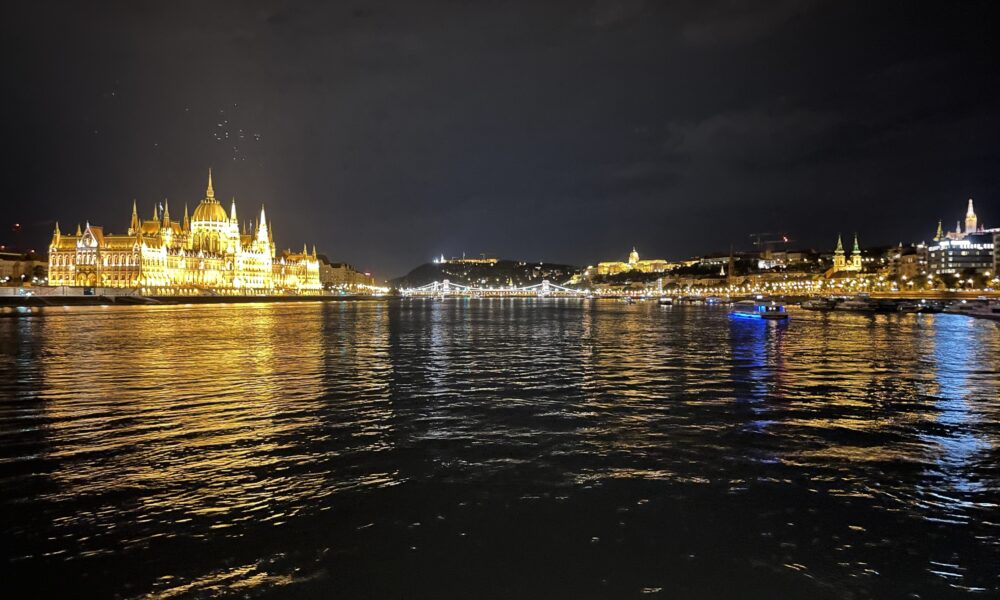 a landscape view of the main attractions on Budapest river at night