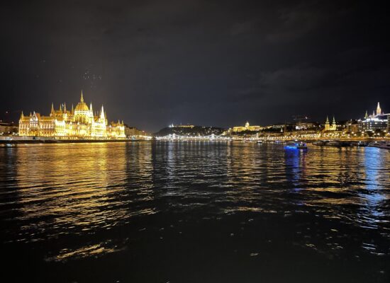 a landscape view of the main attractions on Budapest river at night