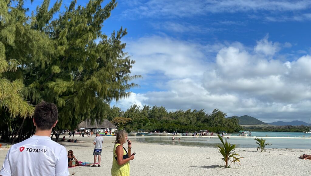 A landscape photo of beachgoers somewhere in Mauritius