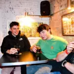 The author and two friends having a drink in Barcelona.