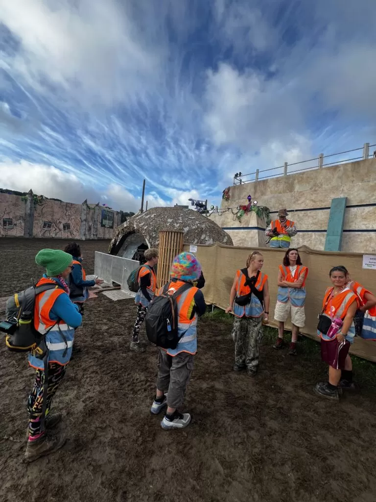 A group of Oxfam Volunteer's in orange hi-vis waiting for their shifts.