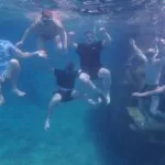 The author and his friends get a photo taken under the water.